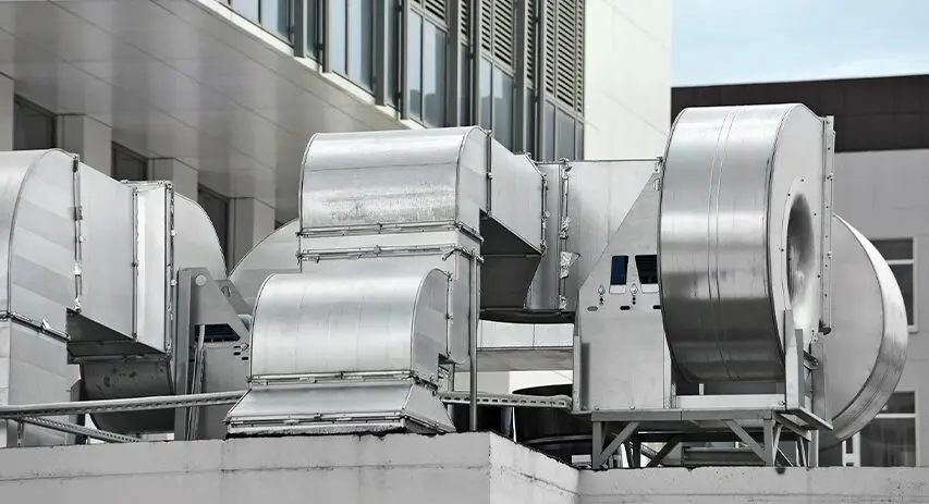 A large industrial air conditioner unit on top of a building.