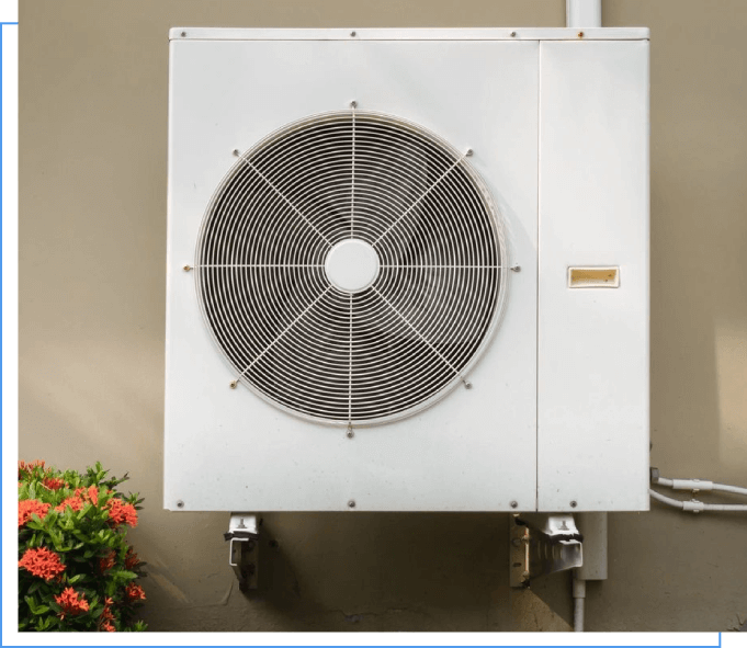 A white air conditioner mounted on the side of a wall.